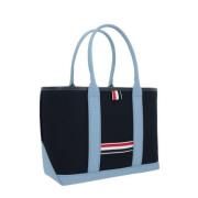 Marineblauwe canvas tote tas met contrastdetails en leren afwerking Th...