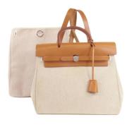 Pre-owned Canvas handbags Hermès Vintage , Beige , Dames