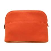 Pre-owned Canvas clutches Hermès Vintage , Orange , Dames